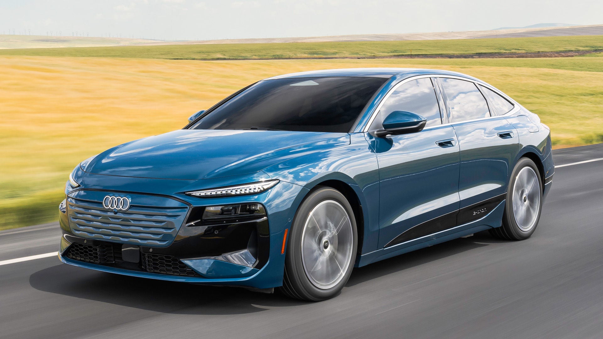 Right side profile view of an Audi A6SB e-tron accelerating. 